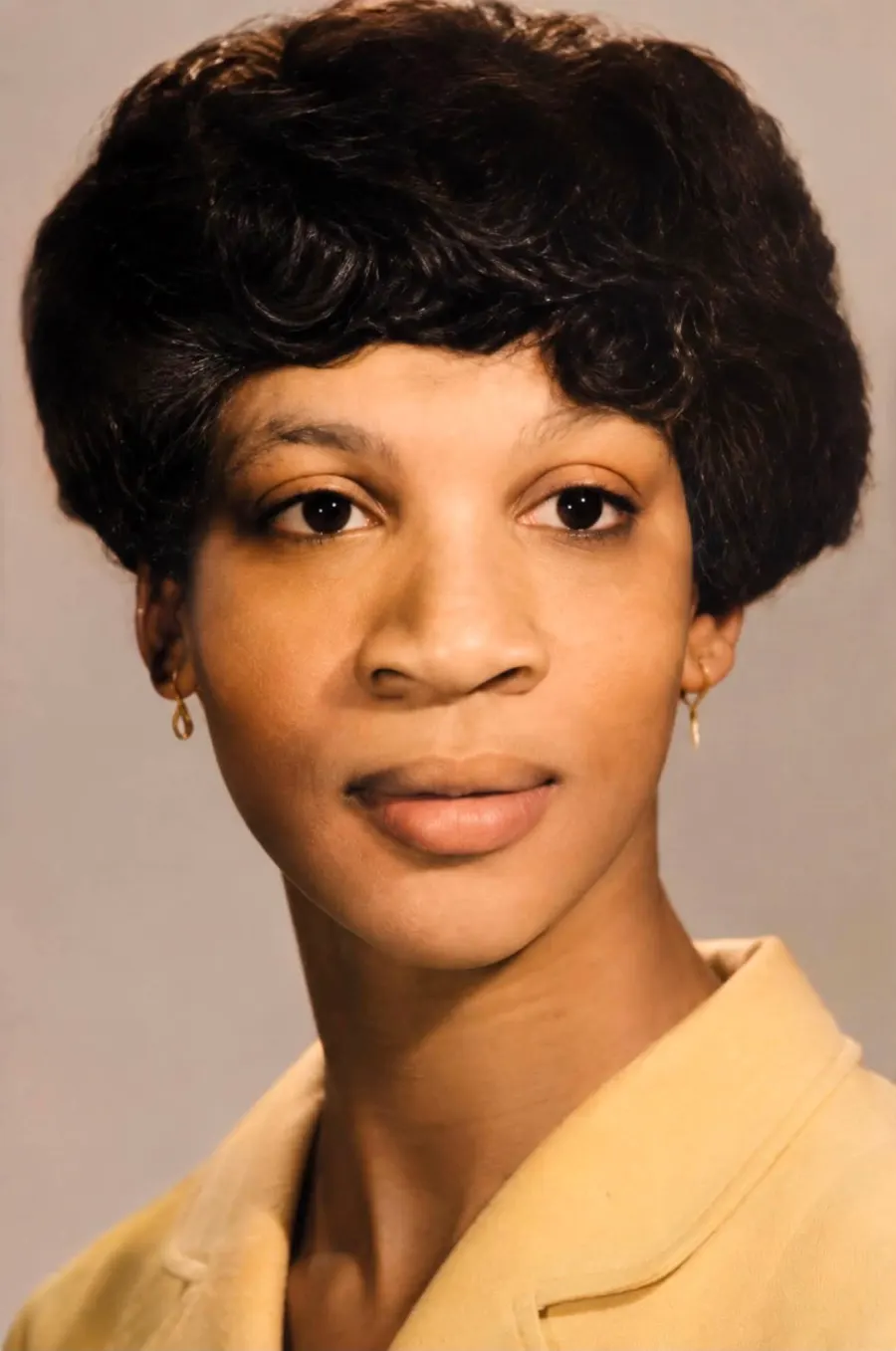 Restored portrait photograph with sharper detail and cleaned-up background